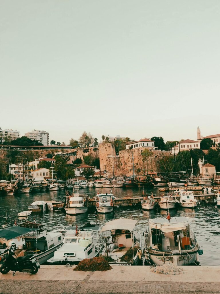 White Boats on Water near Brown Concrete Buildings