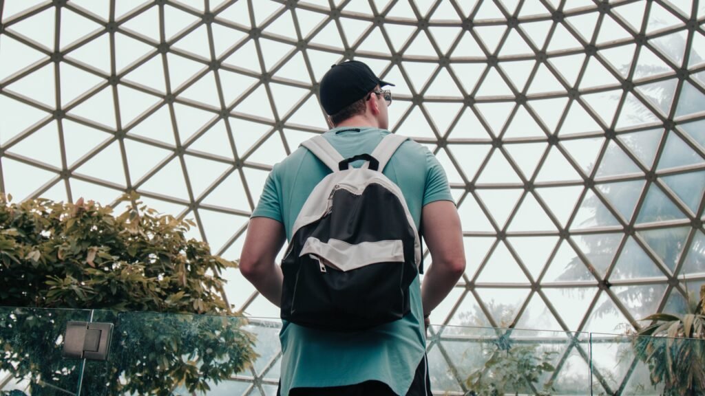 man-standing-under-concrete-building-at-daytime